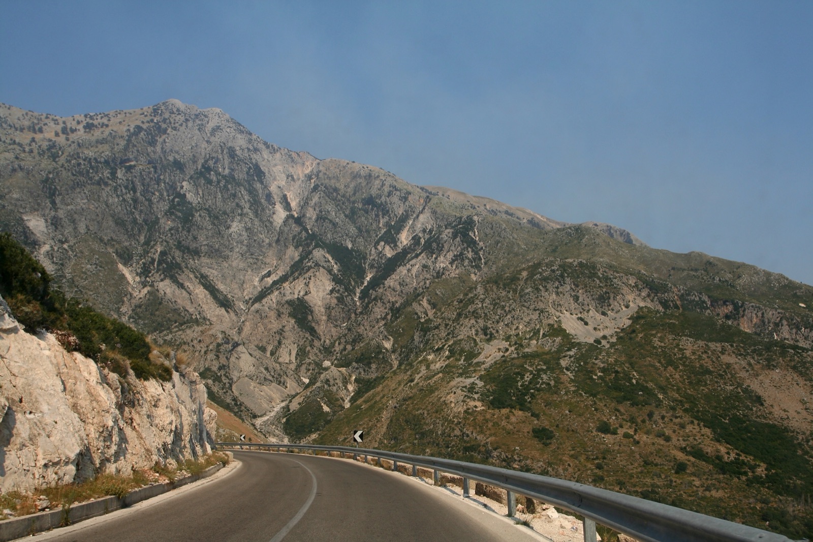 Driver in a rental car on the winding Llogara mountain pass in Albania